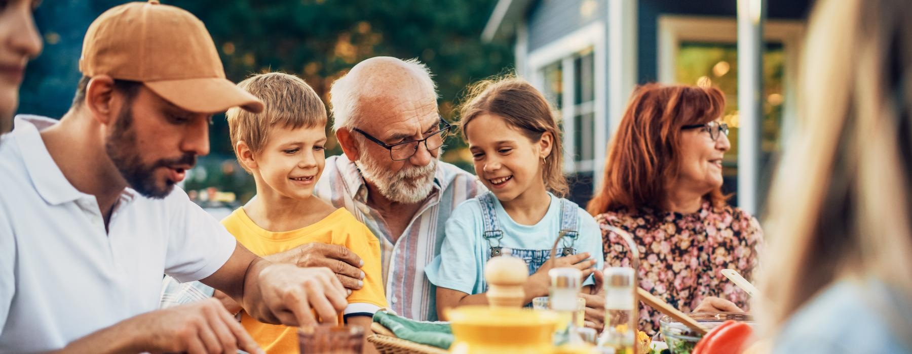 family eating around an outdoor table