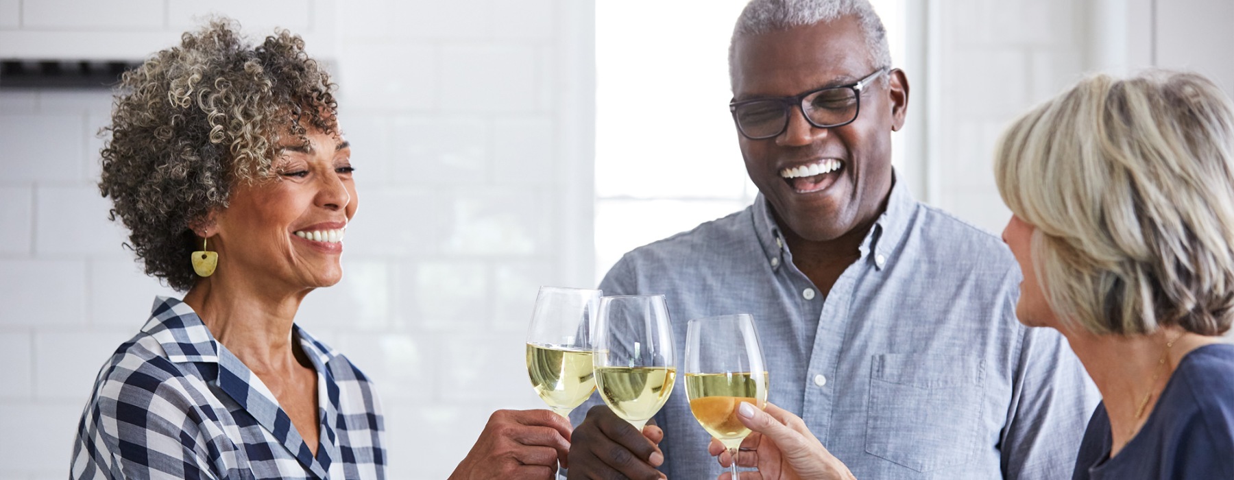 a few people toasting wine glasses