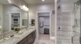 well lit bathroom with brown accents 