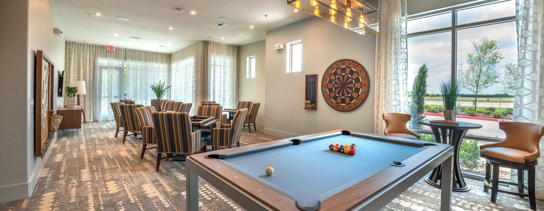 pool table in a room with tables and chairs