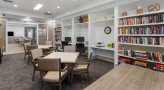 a room with a bookcase and computers