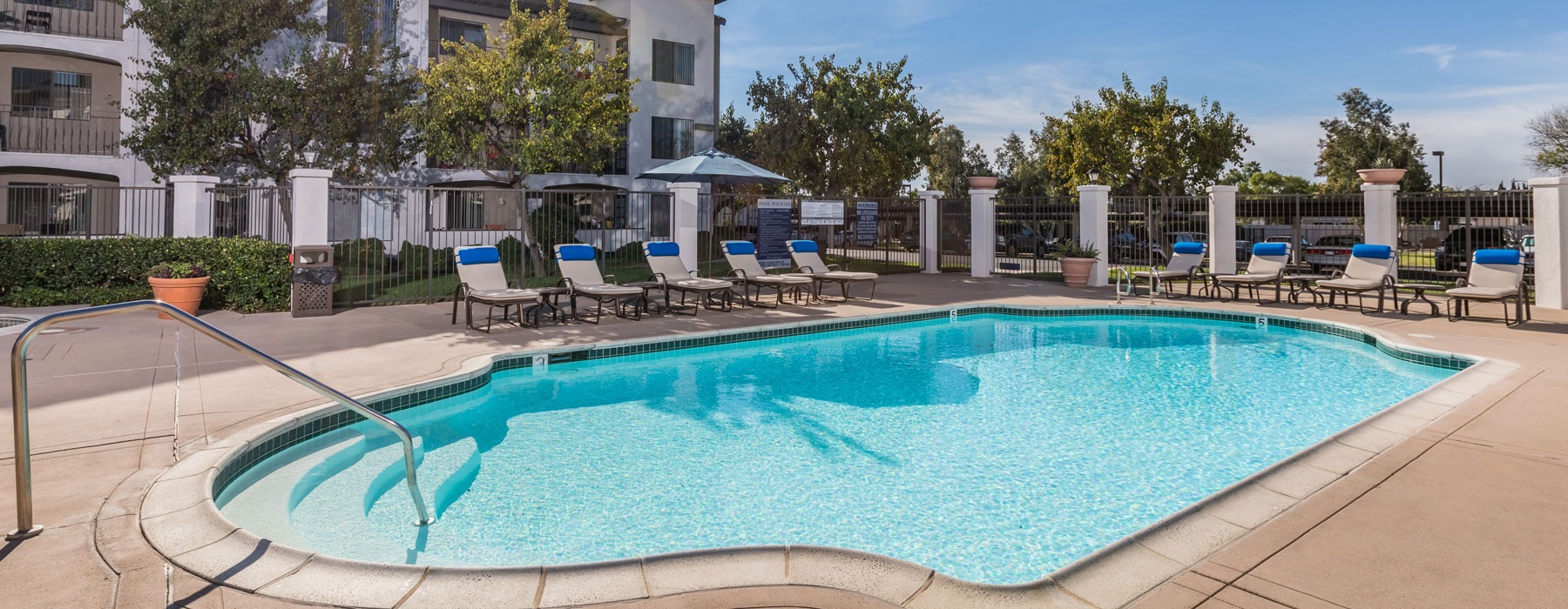 Resort-style swimming pool with lounge seating