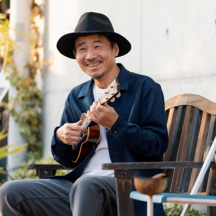 Pursue your passions at Destinations Pebble a man sitting in a chair outside playing a guitar