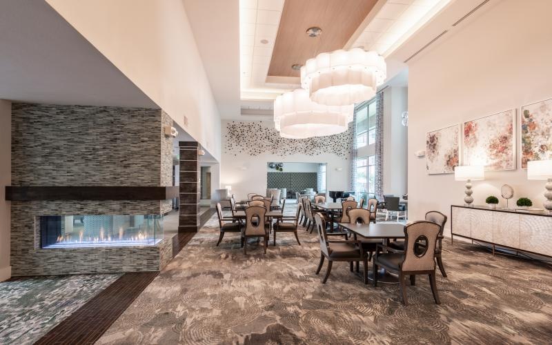 dining room with tables, chairs and a fireplace