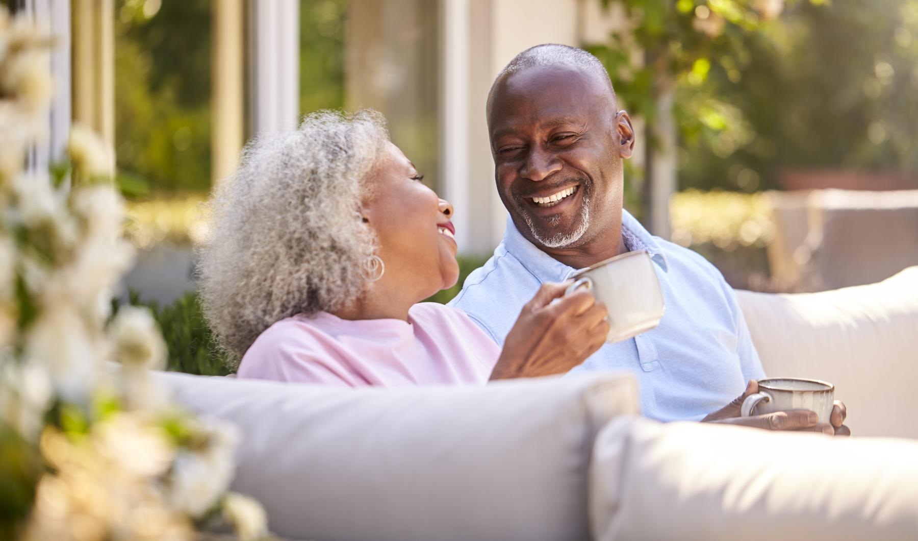 Your Joy to Embrace Couple sitting outside laughing