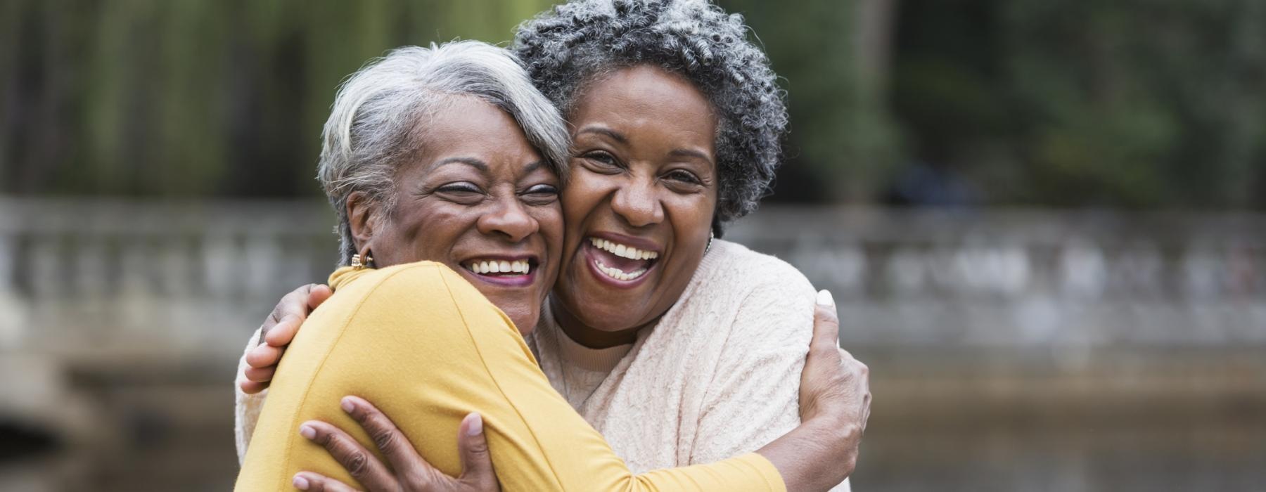 Friends hugging and laughing 