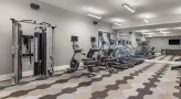 Large fitness center with large windows and plenty of equipment