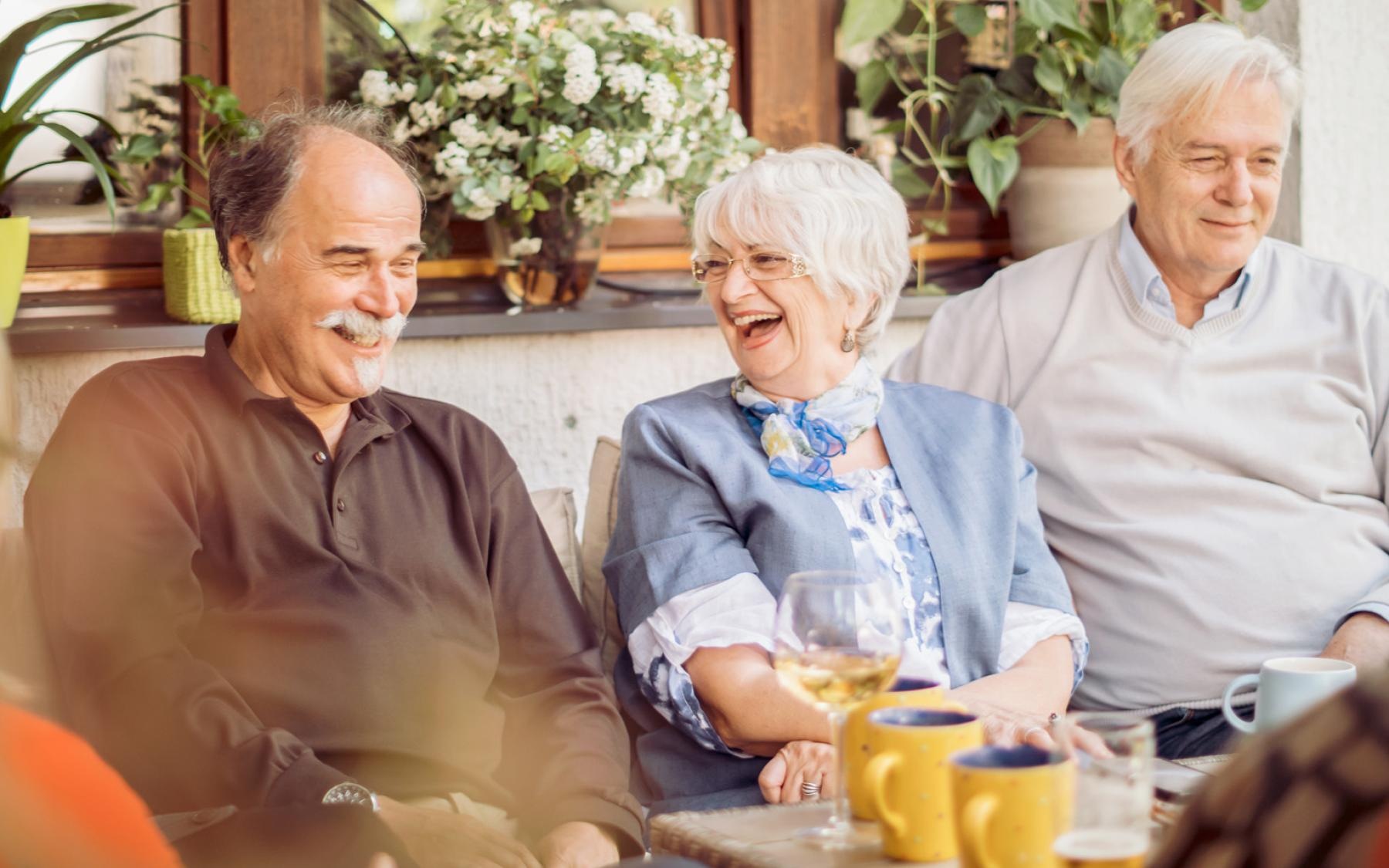 It’s Time to Rethink Your Best Life a group of people drink coffee and laugh around a table
