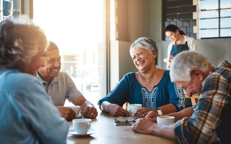 a group of people talking at a table