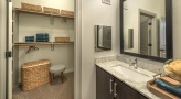 large bathroom with brown accents and closet space