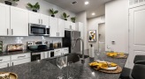 a kitchen with a black countertop