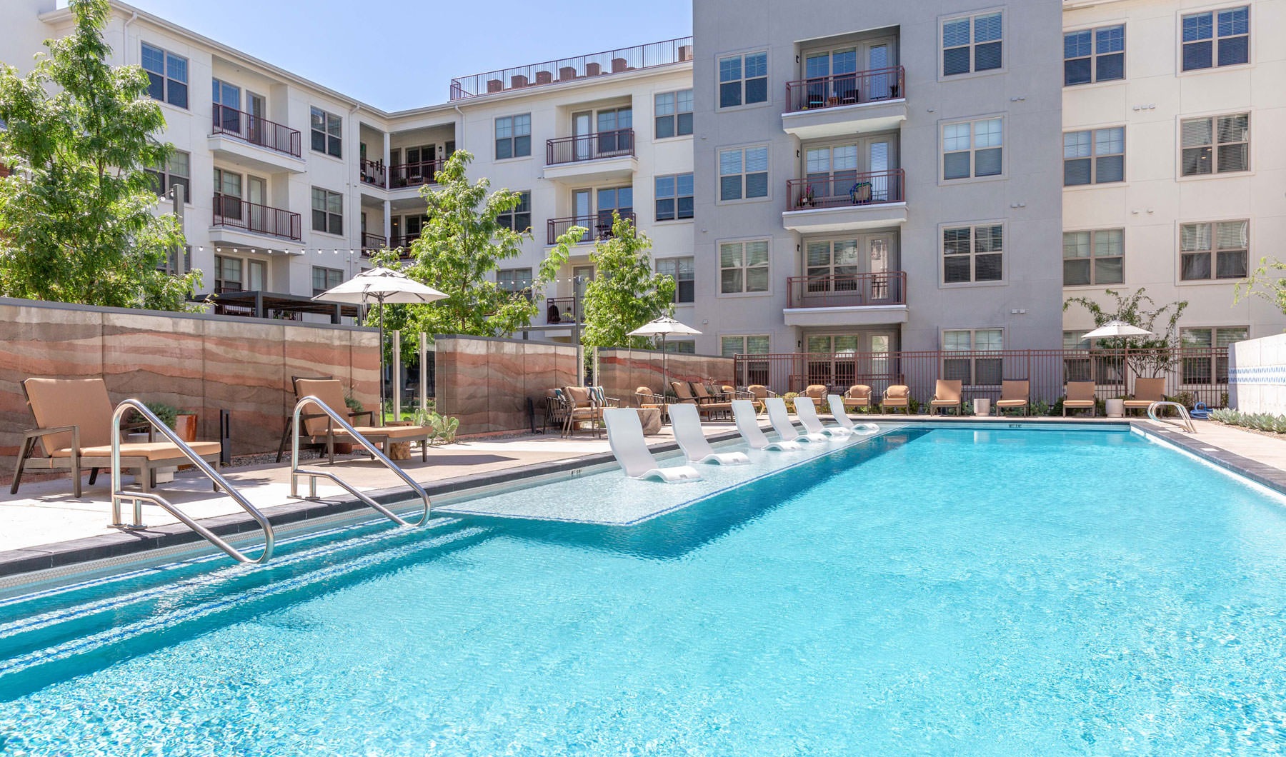 a pool in a courtyard with buildings in the background