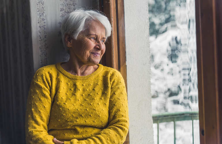 woman looking out her window