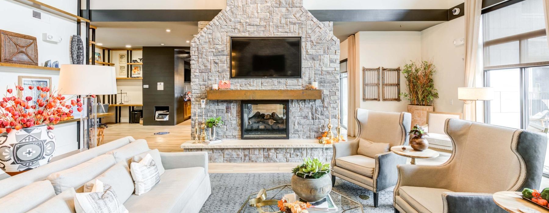 clubhouse with couch and chairs next to fireplace