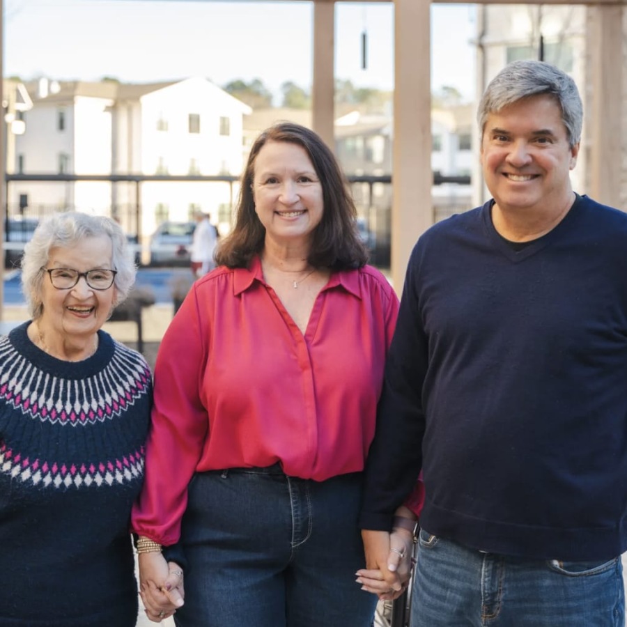 three people standing outside