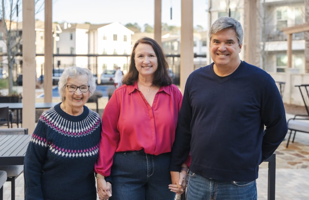 three people standing outside