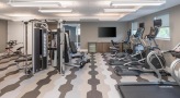 Large fitness center with large windows and plenty of equipment