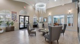 lobby with chairs, chandelier and table