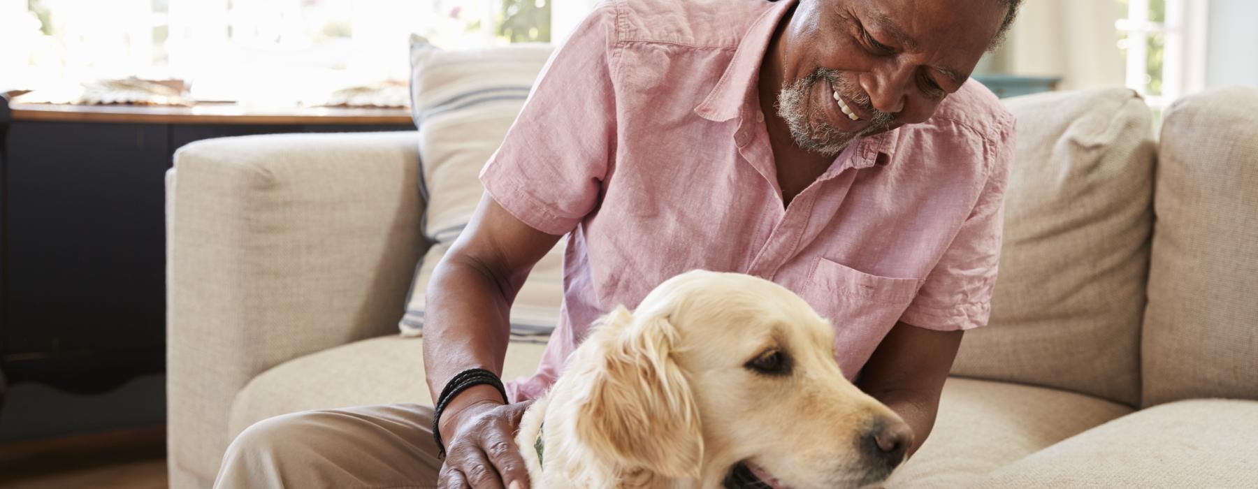 Guy petting his dog 