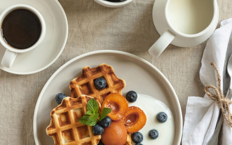 Caffé Caffé a table with a plate of waffles and coffee