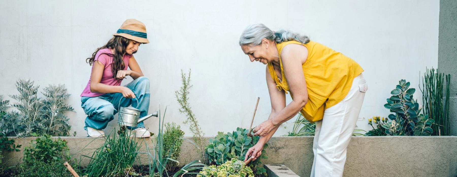 a woman and young girl gardening