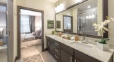 Large bathroom with double vanity sinks and a large mirror