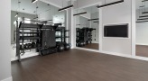 Large fitness center with large windows and plenty of equipment