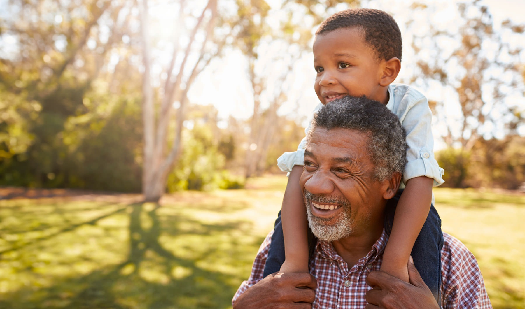 Your Joy to Embrace grandfather carrying his grandson on his shoulders