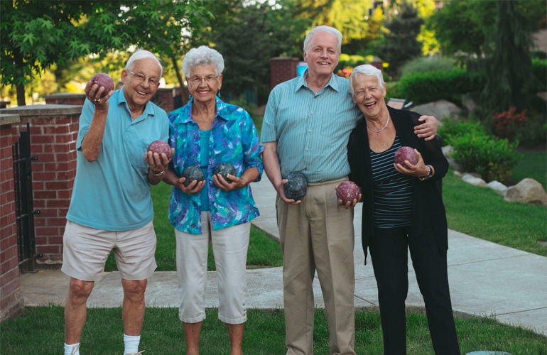 A group of senior adults playing bocce ball.