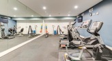 Large fitness center with large windows and plenty of equipment