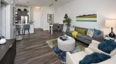 open concept living room with ceiling fan and light fixtures