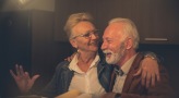 a couple smiling in a warm lighting