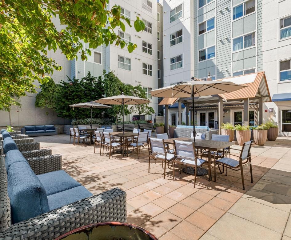 a patio with tables and chairs