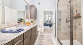 Large bathroom with double vanity sinks and a large mirror