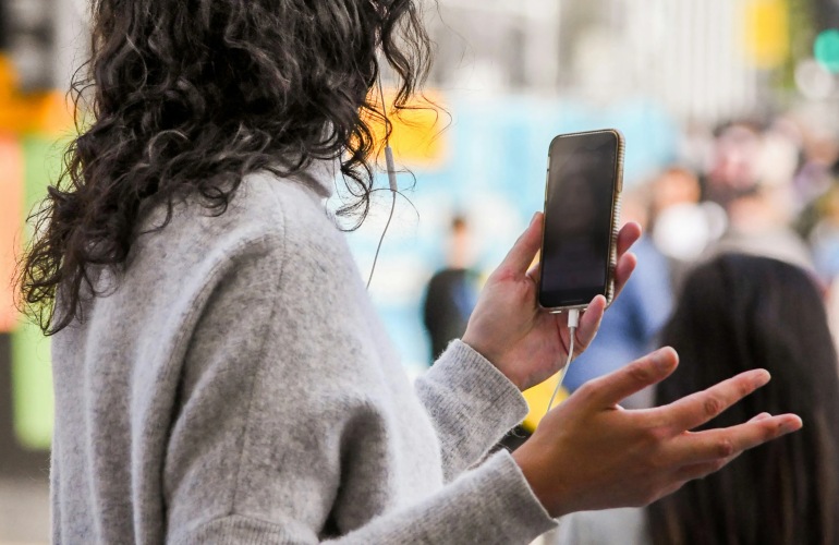 A woman holding a phone