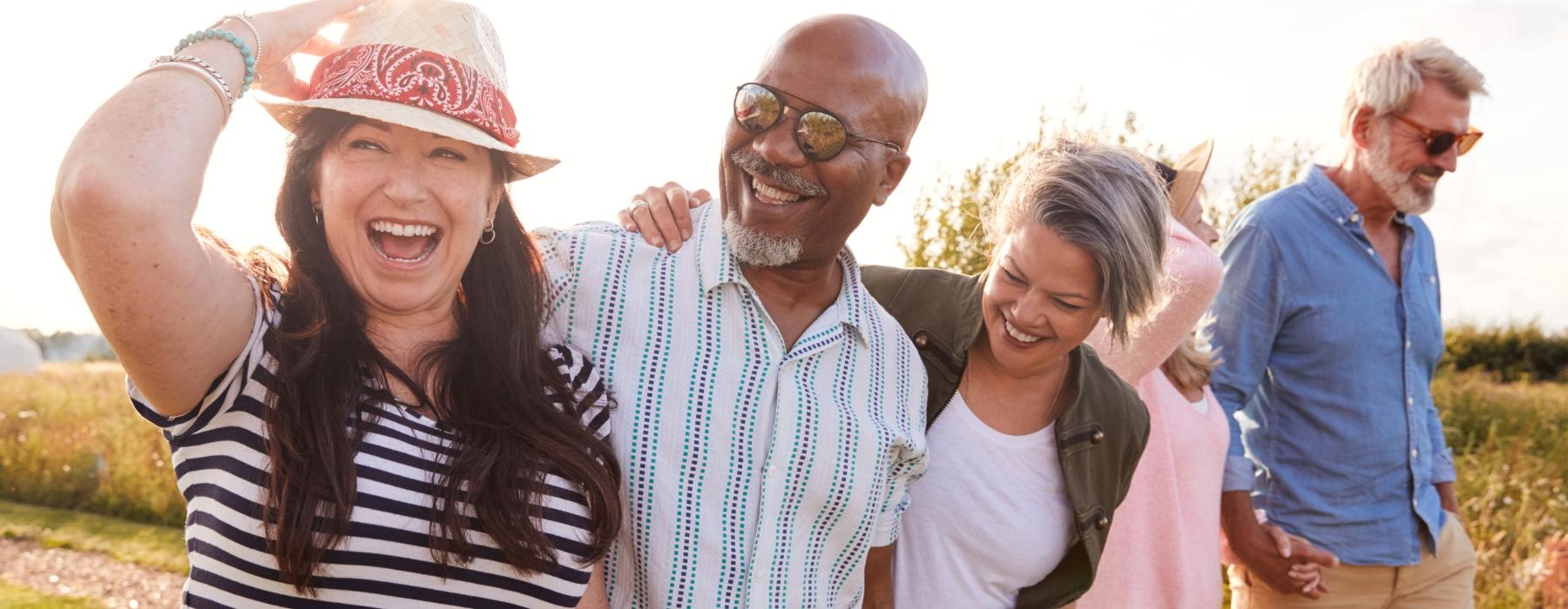 Group of people walking outdoors laughing 