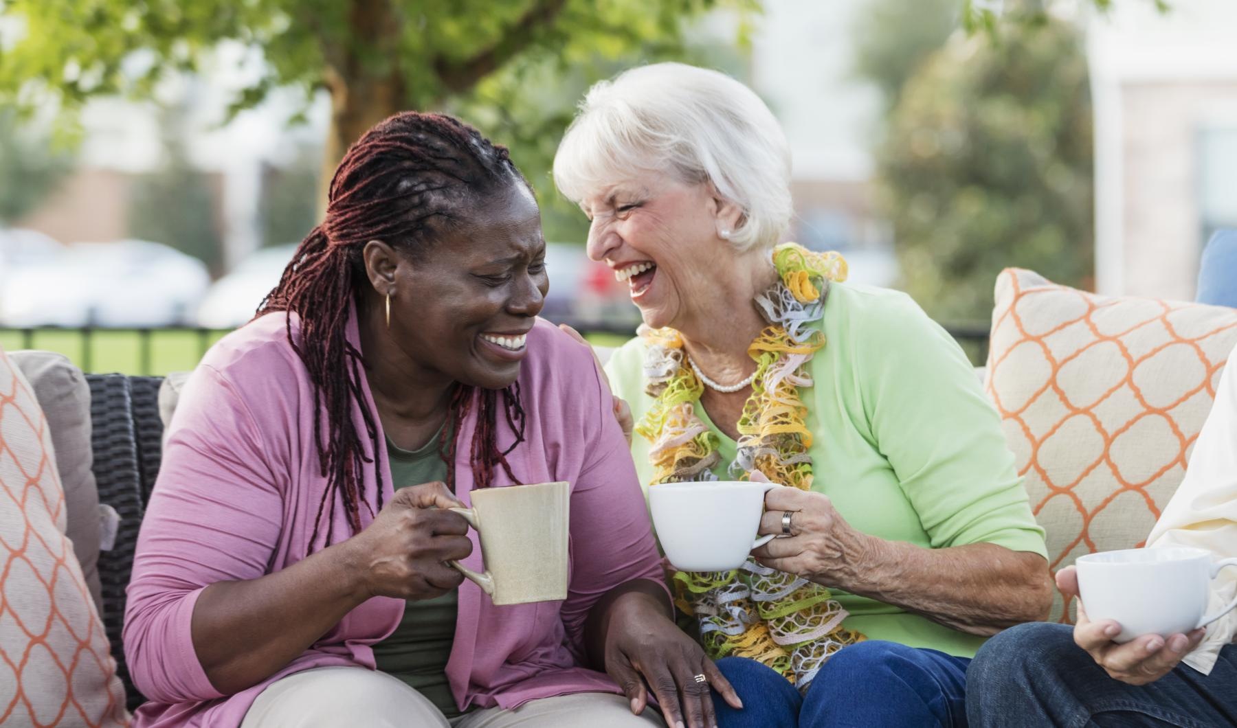 Settle into comfort at Overture Arcadia a couple of women sitting on a couch and laughing