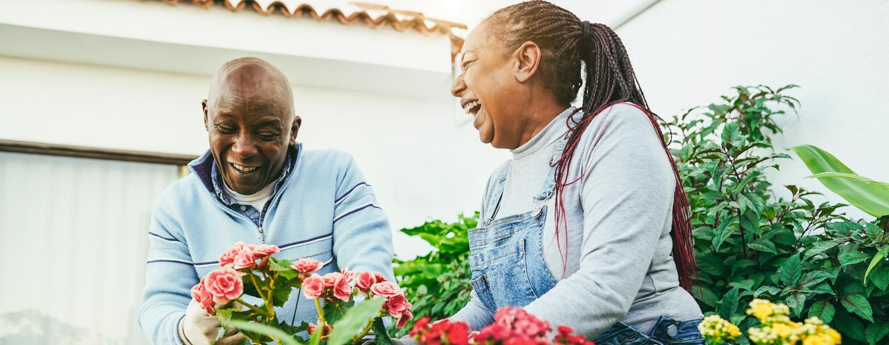 a man and a woman tending to flowers