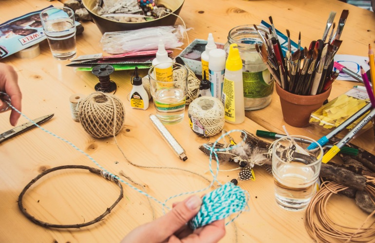 Close up of a craft table with crafts.