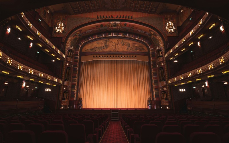 a theater with a stage and chairs