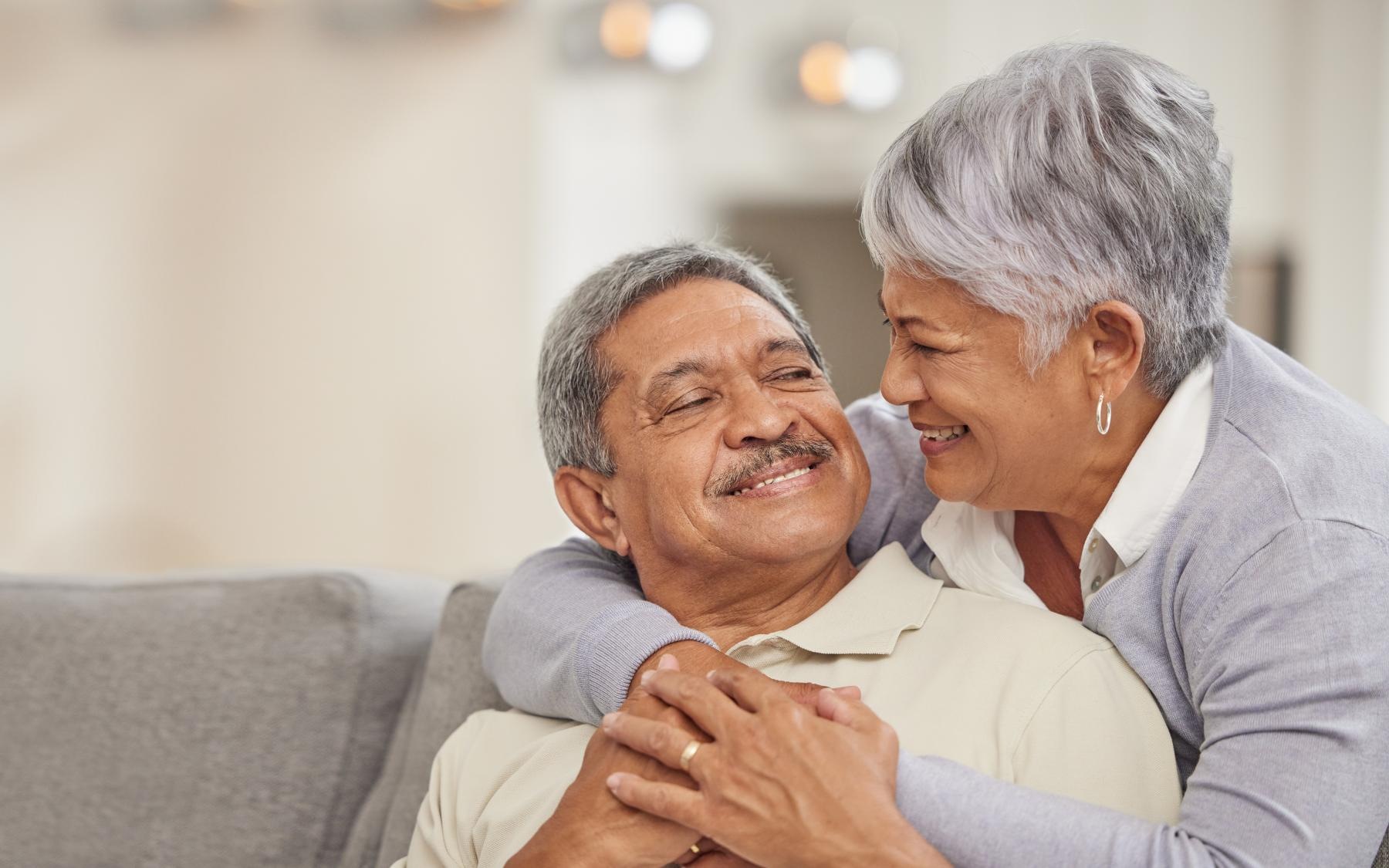 Settle into comfort at Overture San Marcos A man and woman embracing at Destinations Pueblo apartments in Summerlin, Las Vegas, NV, featuring natural lighting.