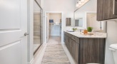 Large bathroom with double vanity sinks and a large mirror