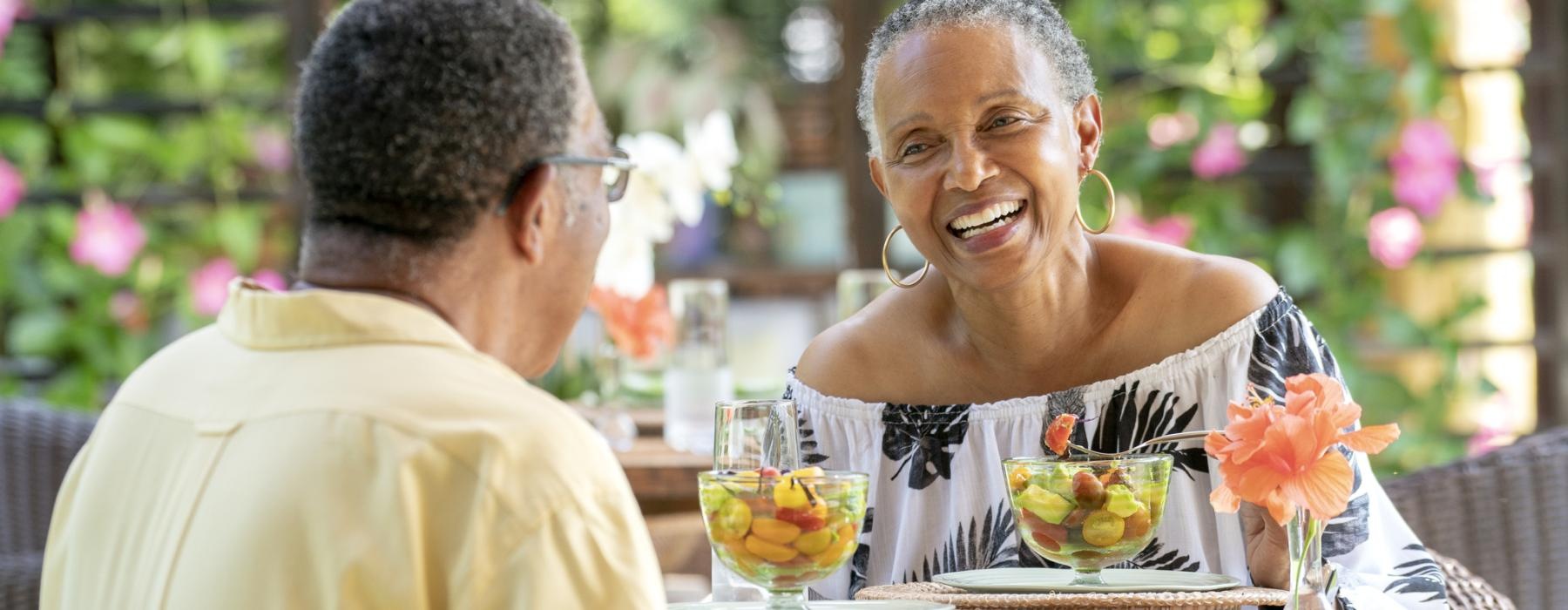 Couple out enjoying drinks smiling 