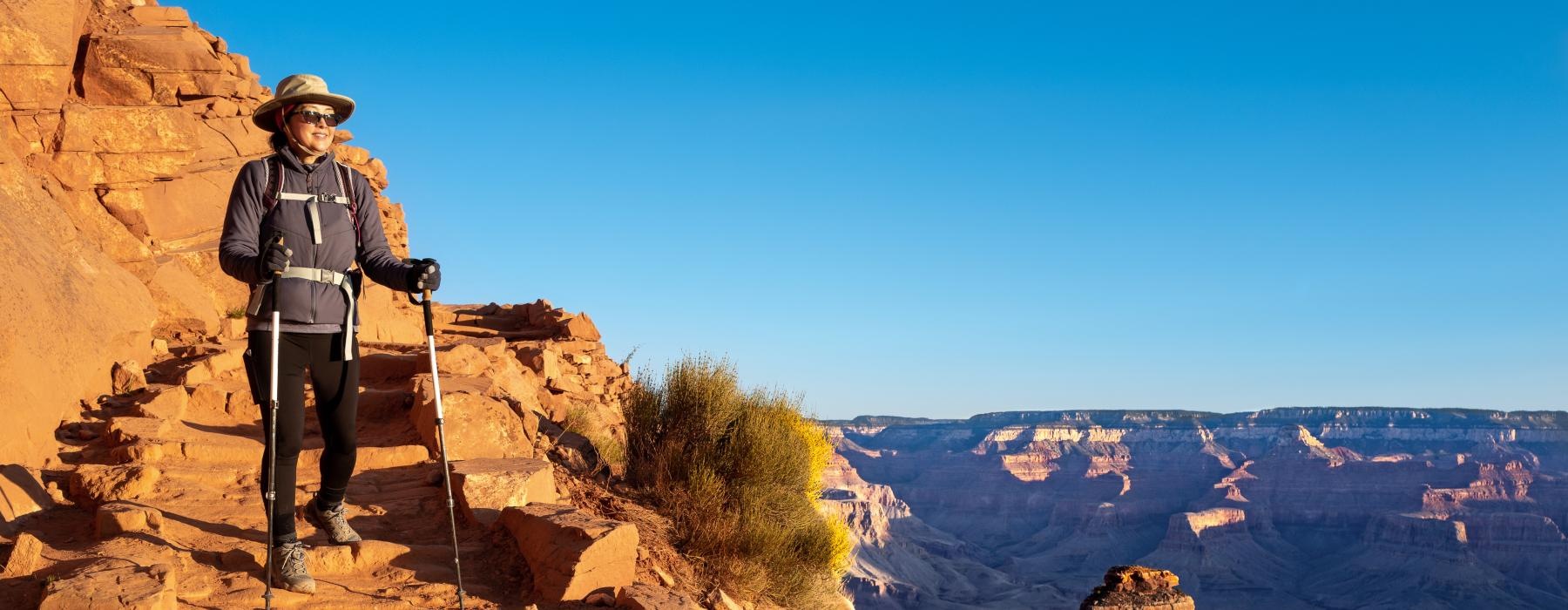 woman hiking down a mountain side