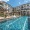 swimming pool in a courtyard with lounge chairs