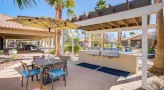 outdoor grilling area with chairs and tables