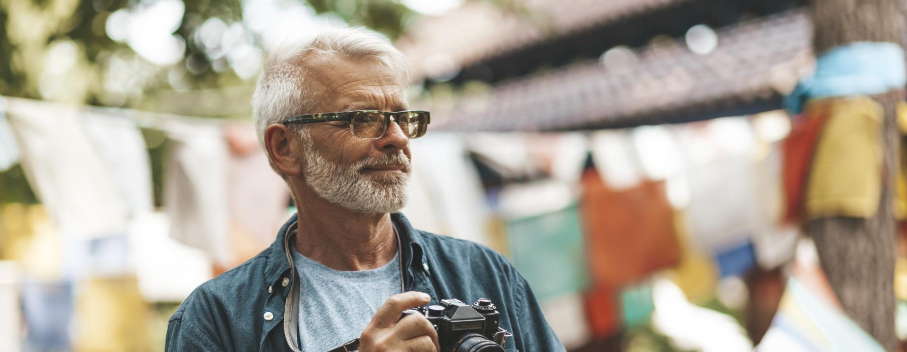 a man outside holding a camera