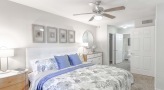 bedroom with a large mirror and ceiling fan