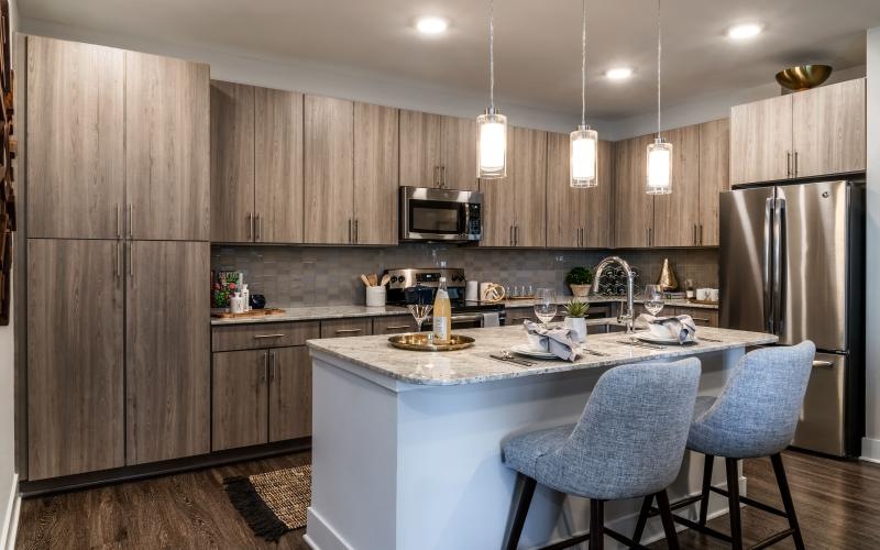 a kitchen with island and ample lighting