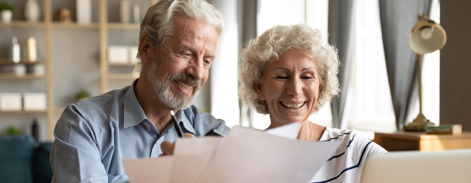 a man and woman looking at paperwork